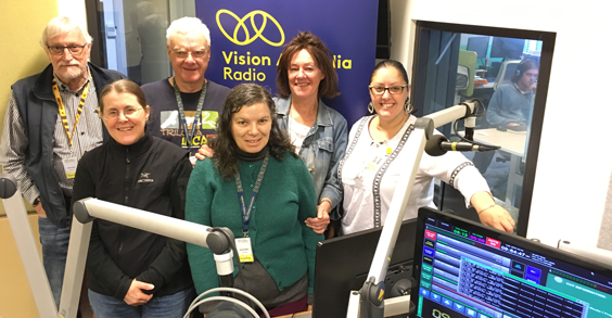 Vision Australia Radio team standing inside the recording studio
